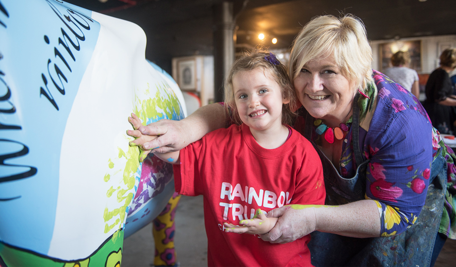 Children paint Rainbow Trust Children’s Charity’s cow for CowParade Surrey